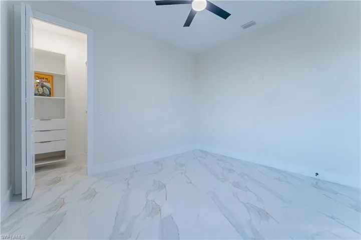 Empty room featuring ceiling fan