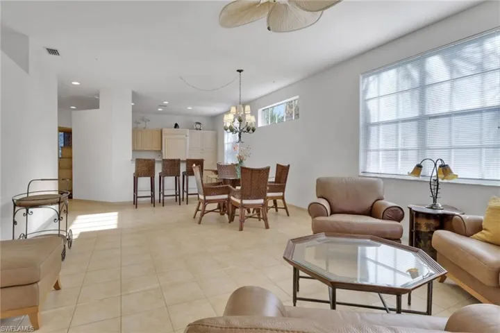 Living room featuring a chandelier, recessed lighting, and ceiling fan