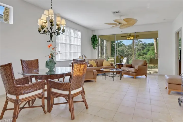 Dining space featuring a ceiling fan and light tile patterned flooring