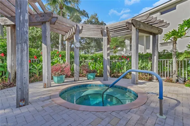View of pool with a community hot tub, a pergola, and a patio