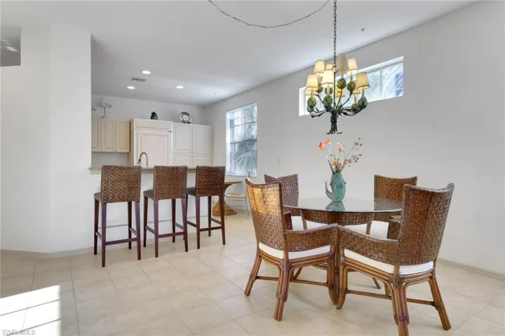 Dining space with recessed lighting, a chandelier, and light tile patterned floors