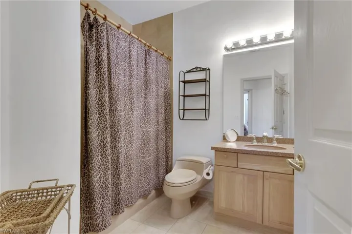 Full bathroom featuring vanity and light tile patterned floors