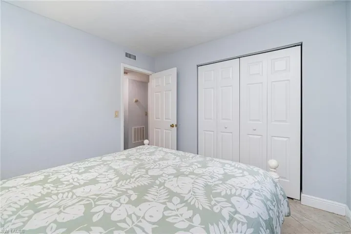 Bedroom featuring a closet and light tile patterned floors