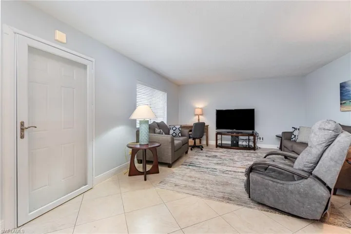 Living room with baseboards and light tile patterned flooring