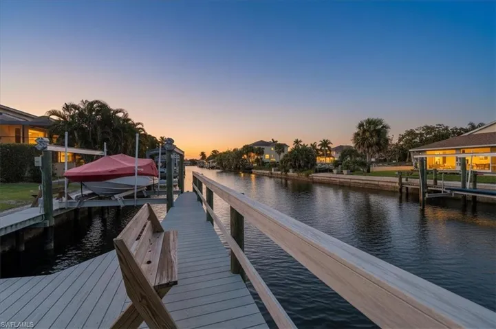 Dock area featuring boat lift and a water view