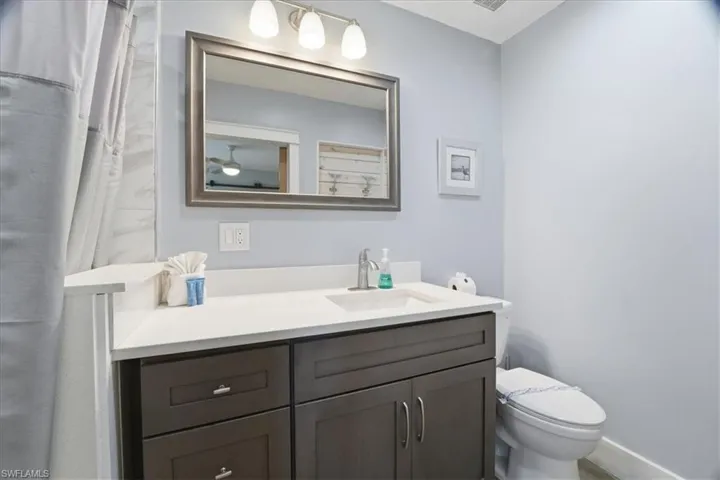Full bath featuring vanity and curtained shower