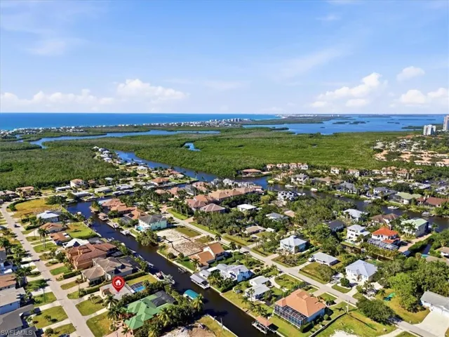 Aerial perspective of suburban area with a nearby body of water