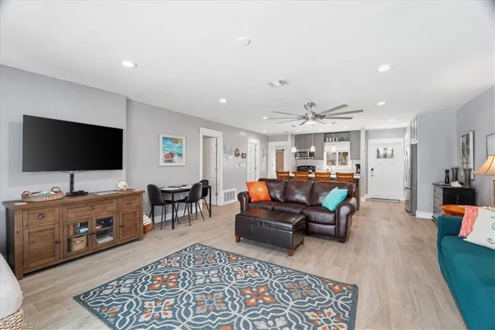 Living area with ceiling fan, light wood-type flooring, and recessed lighting