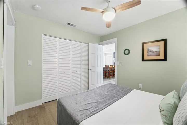Bedroom featuring light wood-type flooring, a closet, and ceiling fan