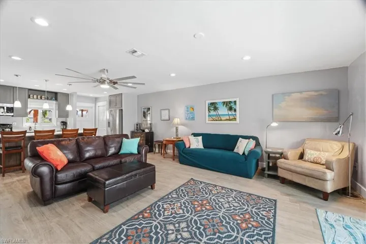Living area featuring a ceiling fan, light wood-type flooring, and recessed lighting