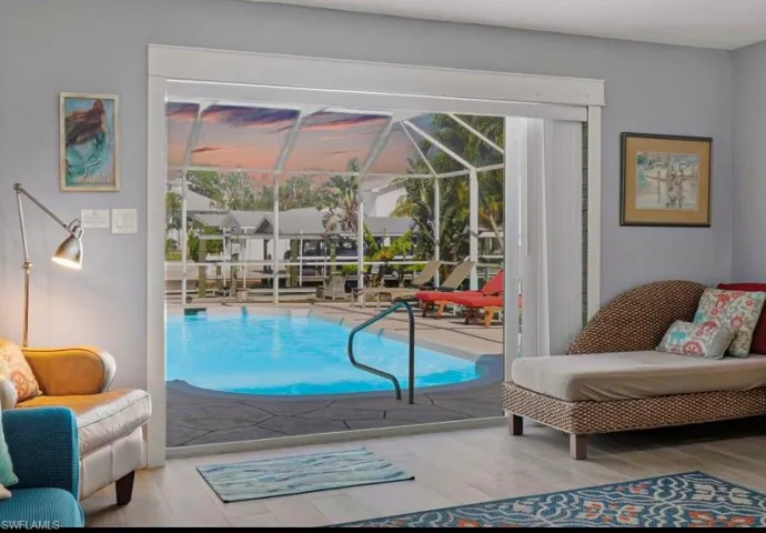 Living area featuring a sunroom, healthy amount of natural light, and light wood-type flooring