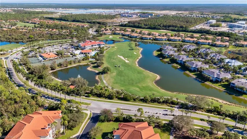 Birds eye view of property with a water view