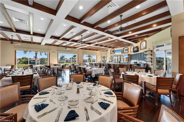 Dining room with beamed ceiling, ceiling fan, wood-type flooring, and coffered ceiling