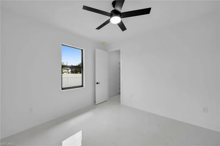 Unfurnished room featuring ceiling fan
