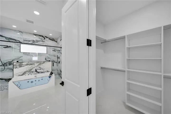 Walk in closet featuring tile patterned flooring