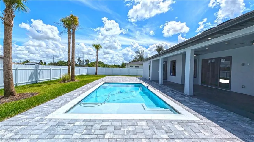 View of swimming pool featuring ceiling fan and a patio