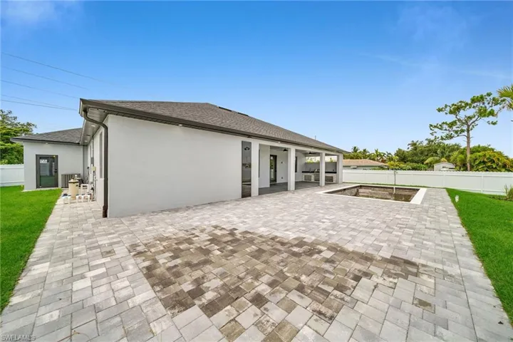 Back of property with a patio area and a lawn