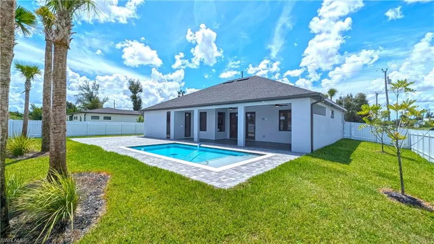 View of swimming pool featuring a lawn and a patio area