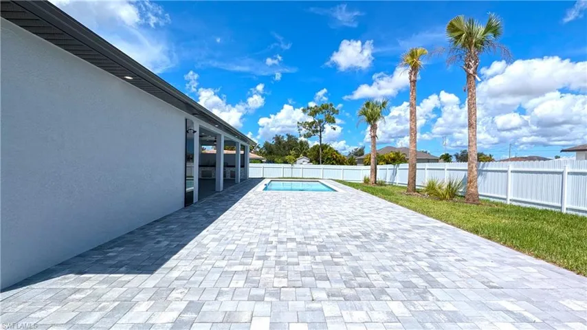 View of patio with a fenced in pool
