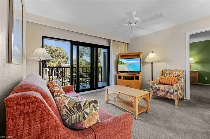 Living room featuring carpet floors and ceiling fan