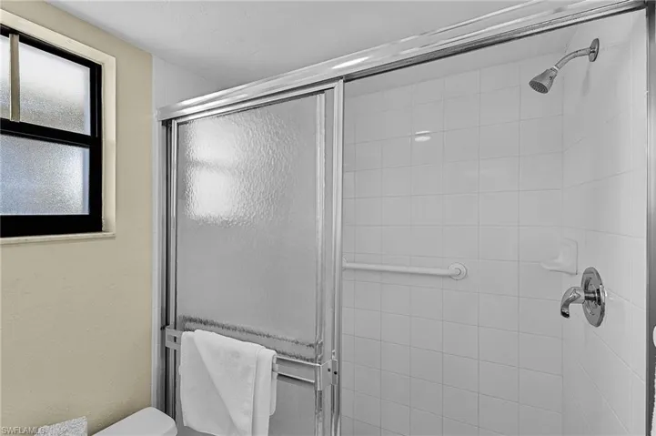 Bathroom featuring walk in shower and toilet