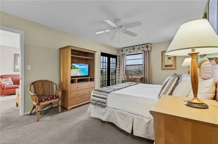 Bedroom featuring ceiling fan and carpet