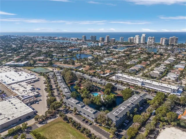 Birds eye view of property with a water view