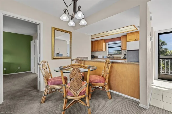 Dining area with sink, a chandelier, and carpet floors