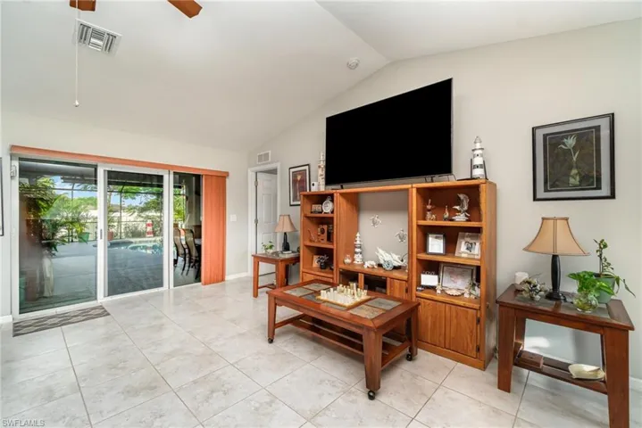Living room with sliders to the lanai and pool area.