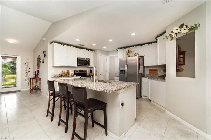 Kitchen with stainless steel appliances and granite.