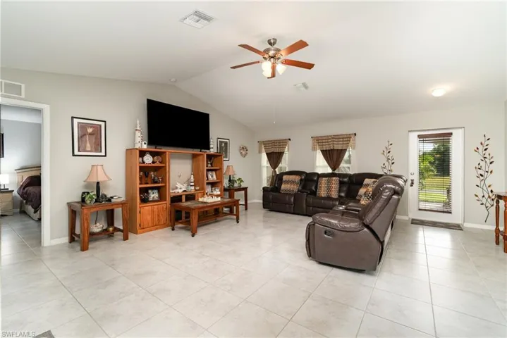Living room features a vaulted ceiling.