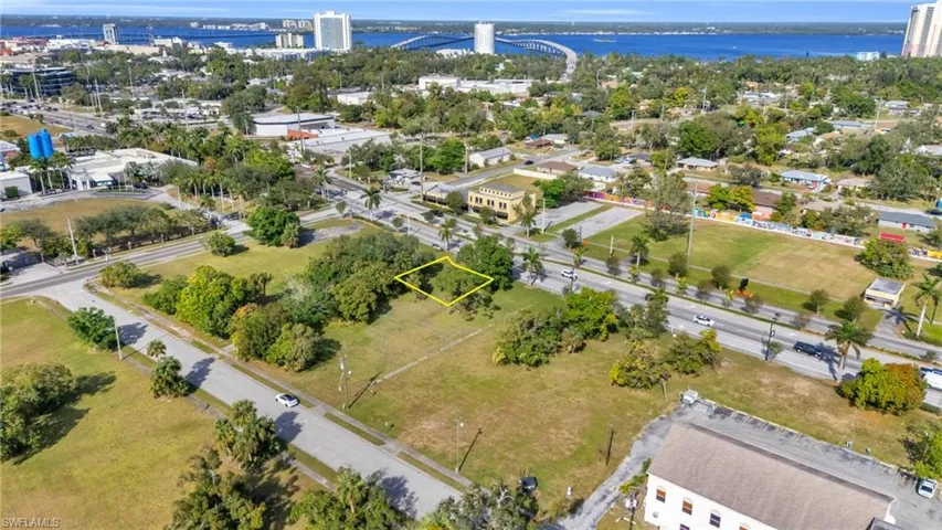 Aerial overview of property's location with a notable bridge, property boundaries highlighted, and a large body of water