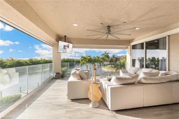 View of patio with an outdoor living space and a ceiling fan
