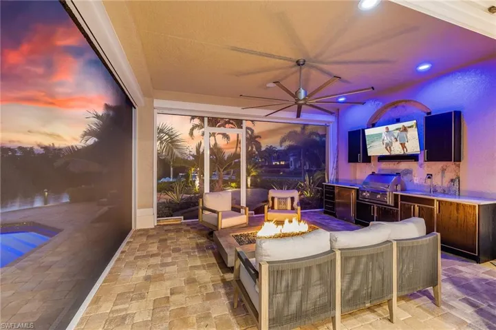 View of patio / terrace with an outdoor living space with a fire pit, a swimming pool, and area for grilling