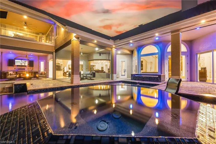 View of swimming pool with ceiling fan