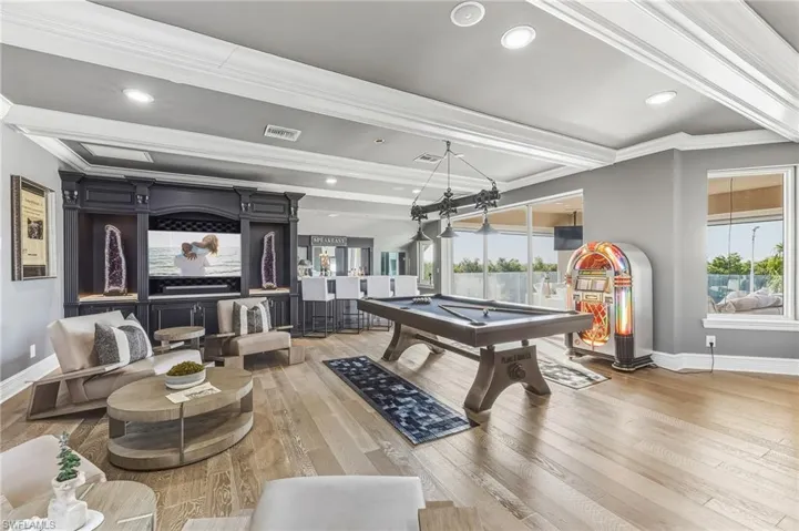 Recreation room with billiards table, recessed lighting, hardwood / wood-style floors, and crown molding