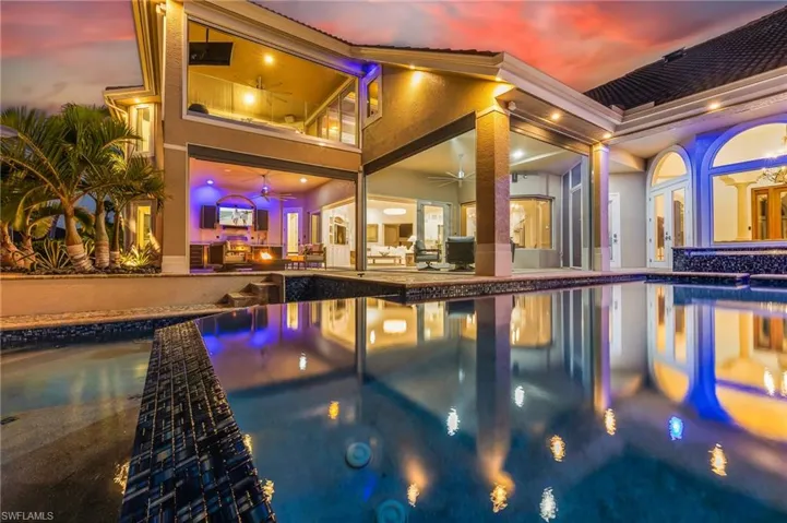 Outdoor pool with a patio area and an in-ground hot tub