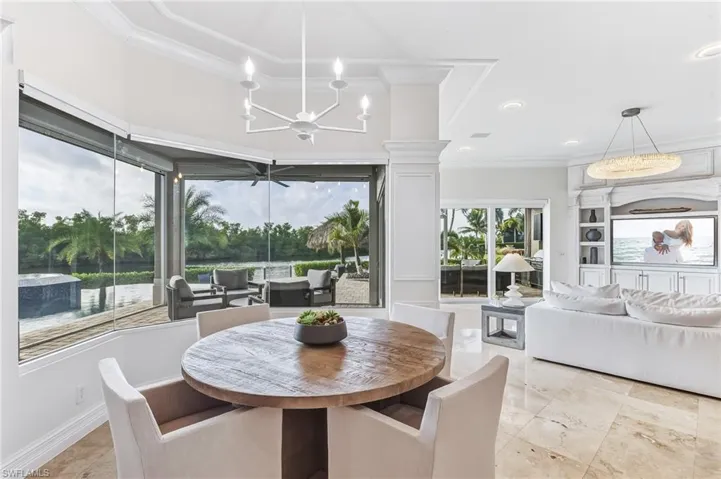 Dining space with ornamental molding and a chandelier