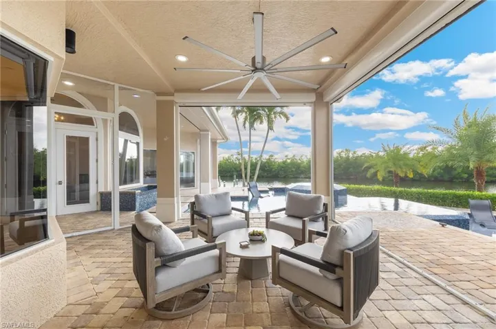 View of patio with an outdoor hangout area and ceiling fan