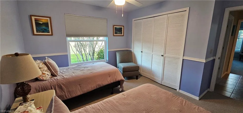 Bedroom featuring ceiling fan, carpet flooring, and a closet