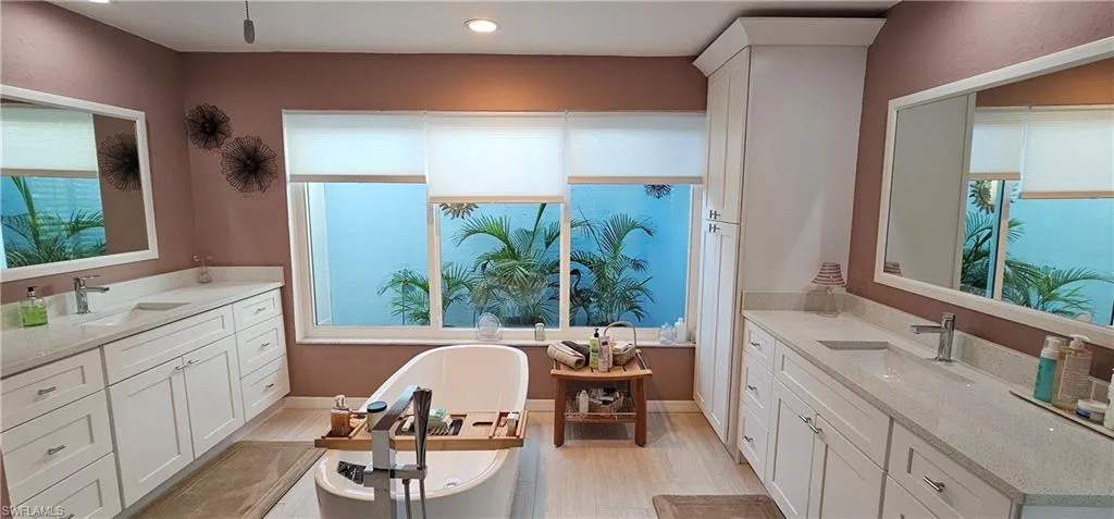 Bathroom featuring hardwood / wood-style floors, a bathtub, and vanity