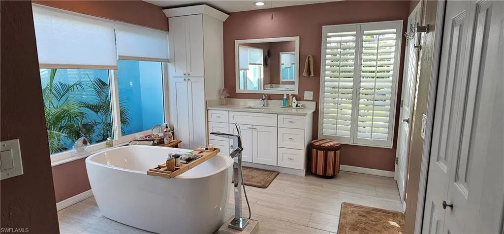 Bathroom featuring vanity and a bath