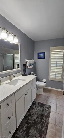 2nd updated full Bathroom with new tile flooring, vanity with quartz countertop