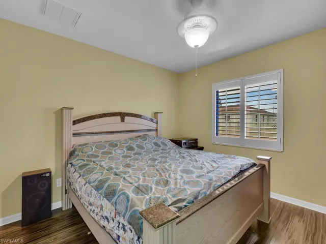 Bedroom with dark wood-type flooring