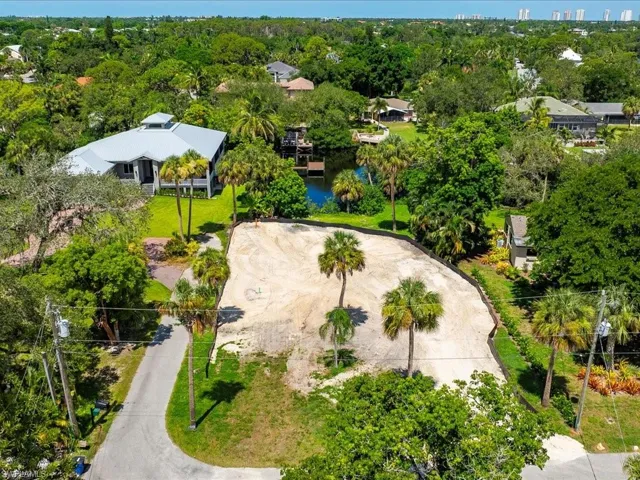 Aerial overview of property's location with a nearby body of water and nearby suburban area
