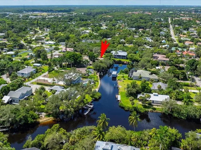 Aerial perspective of suburban area featuring a large body of water
