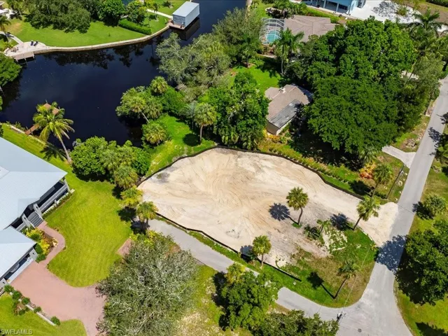 View of property location featuring a large body of water and nearby suburban area