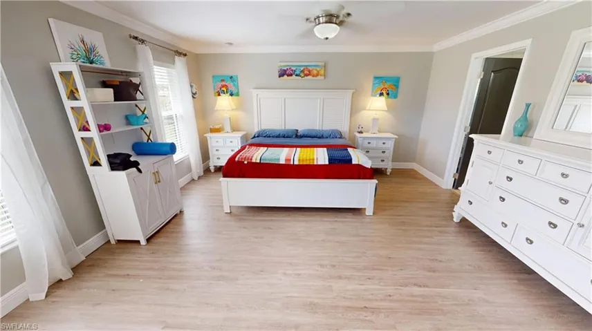 Bedroom featuring light hardwood / wood-style flooring and crown molding