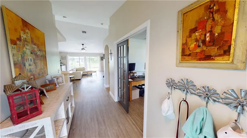 Corridor with hardwood / wood-style floors