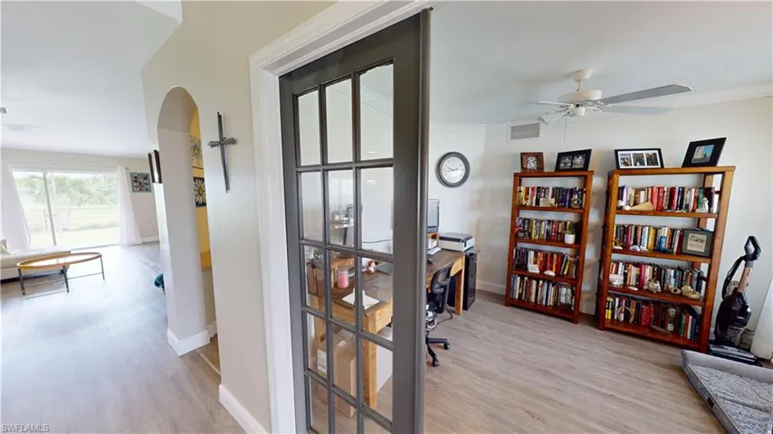 Office with ceiling fan, crown molding, and light hardwood / wood-style flooring